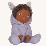 Olli Ella purple coloured Babs Bunny Dinky Dinkum Doll in a seated position. The bunny ear hood is pulled down showing the curly dark coloured hair