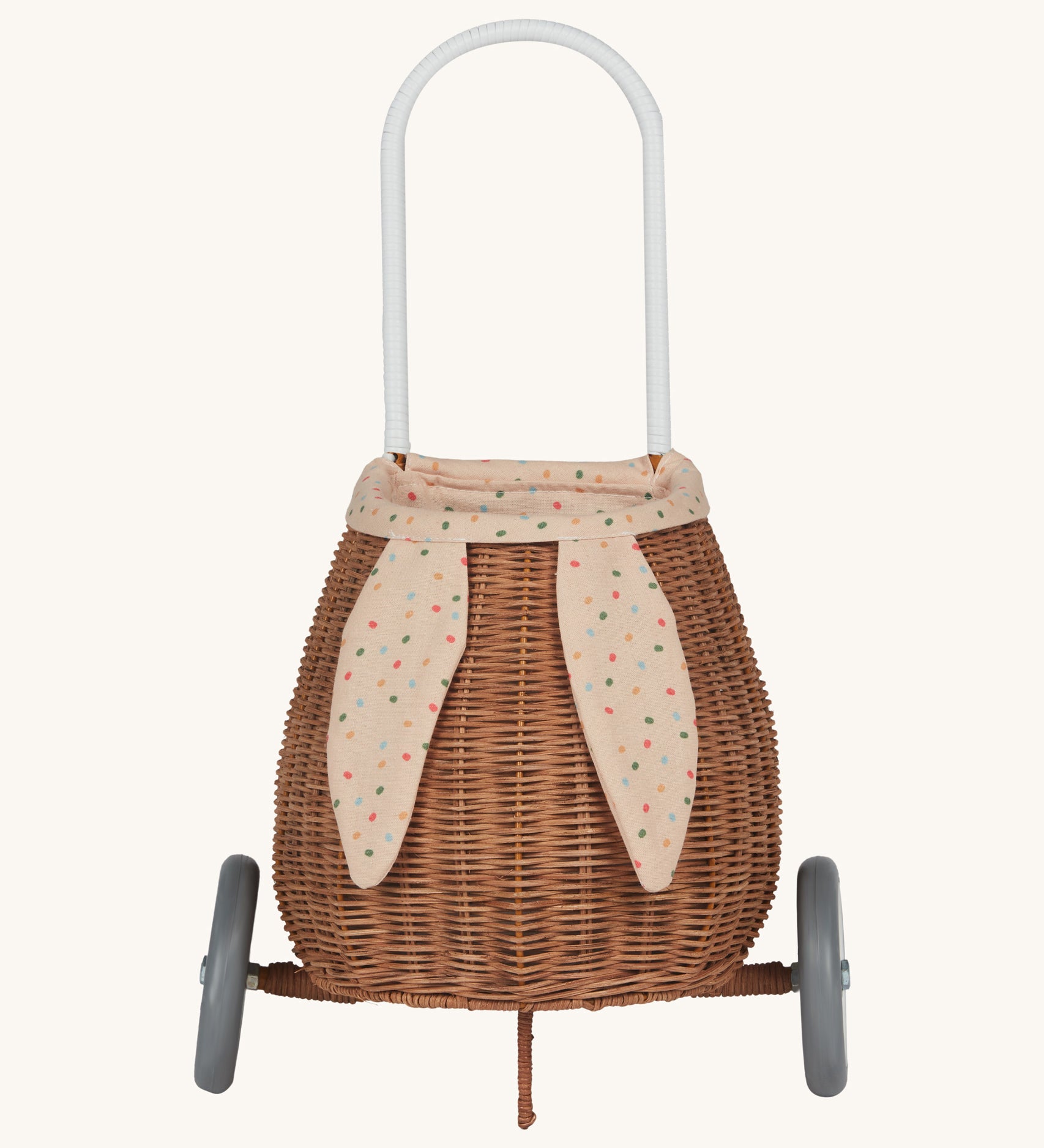 Olli Ella Rattan Bunny Luggy with Lining – Gumdrop. A beautifully woven Luggy roll along basket with a light peach lining and gum drop detail.