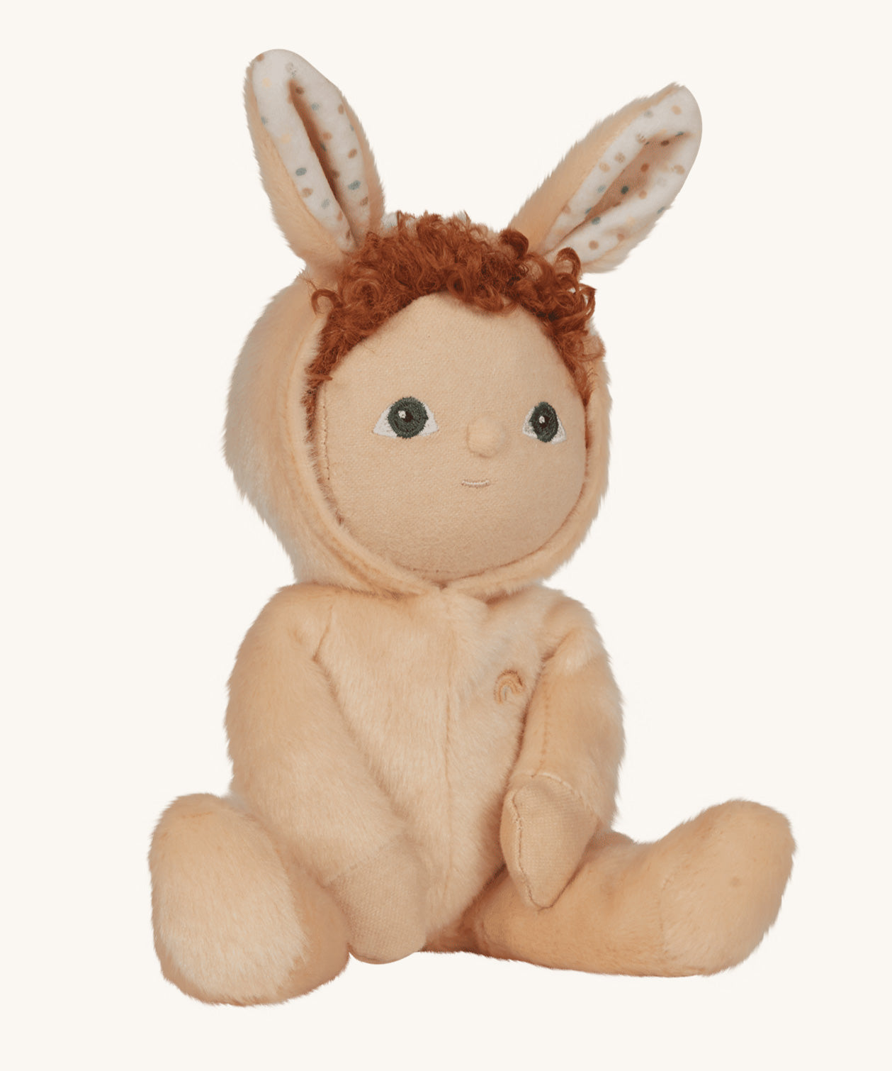 Olli Ella light sand coloured Bubba Bunny Dinky Dinkum Doll in a seated position. The dolly's red coloured curly hair can be seen peeping out from underneath the bunny eared hood. 