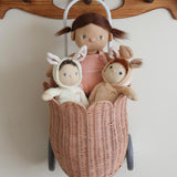 Two Olli Ella Bunny Dinky Dinkum Dolls in a pink basket with a Dinkum doll