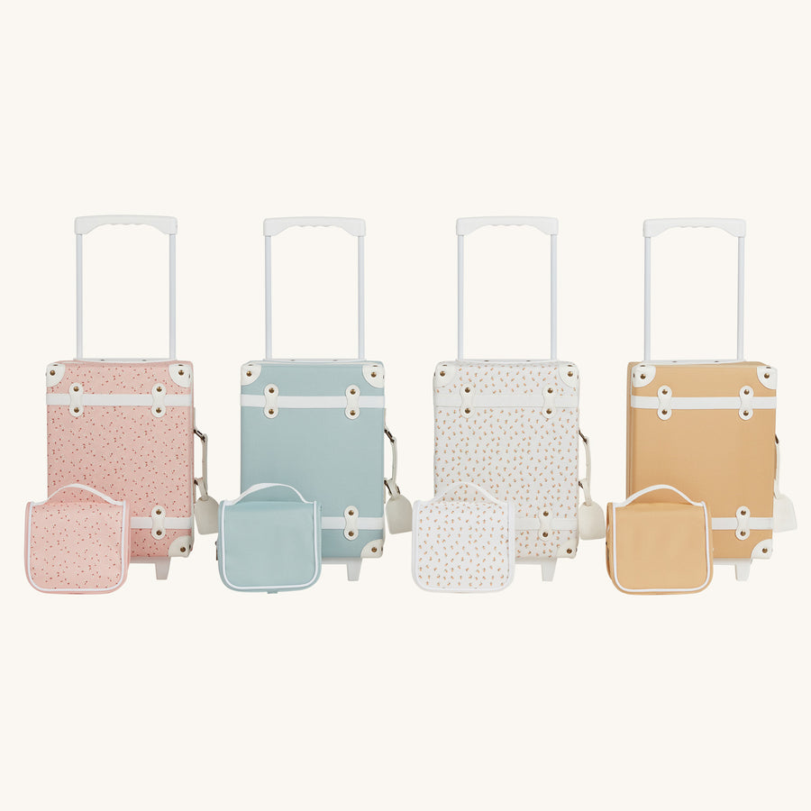 Collection of four new olli ella suitcases with matching wash bags pictured on a plain background