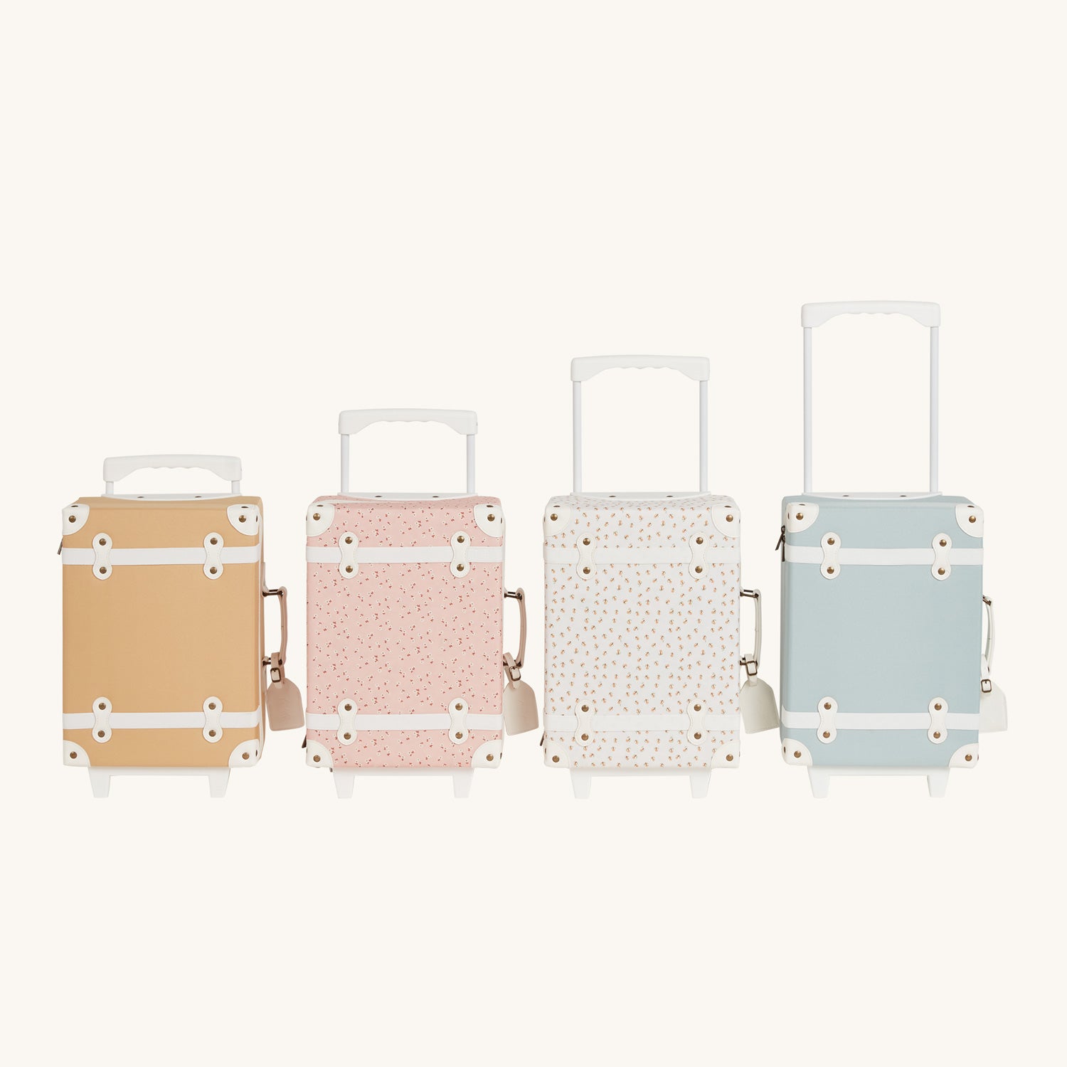 Collection of four Olli Ella See-ya suitcases with handles extended and a Dinky Dinkum on each pictured on a plain background