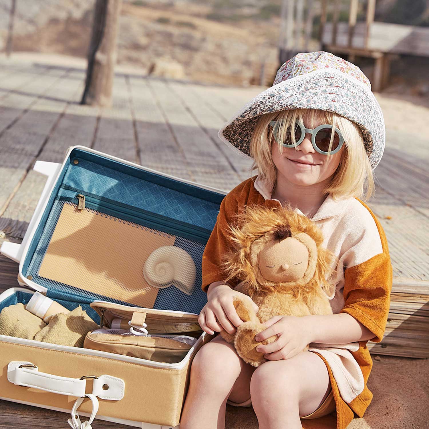 Child pulling the Butterscotch colours suitcase along with another child in front with the steel blue one