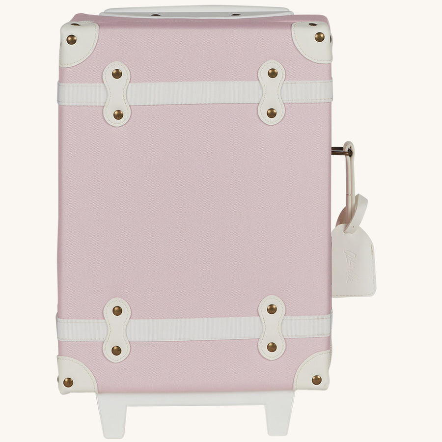 Olli Ella See-Ya Kids Travel Suitcase - Sorbet. A kids-sized suitcase for mini travellers in a beautiful light pink, white details with metal studs, on a cream background