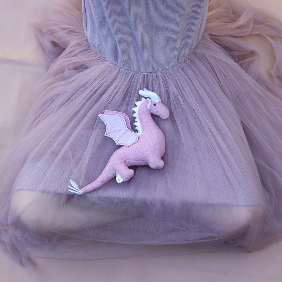 Unicorn and Dragon on a grey tulle skirt held by a child