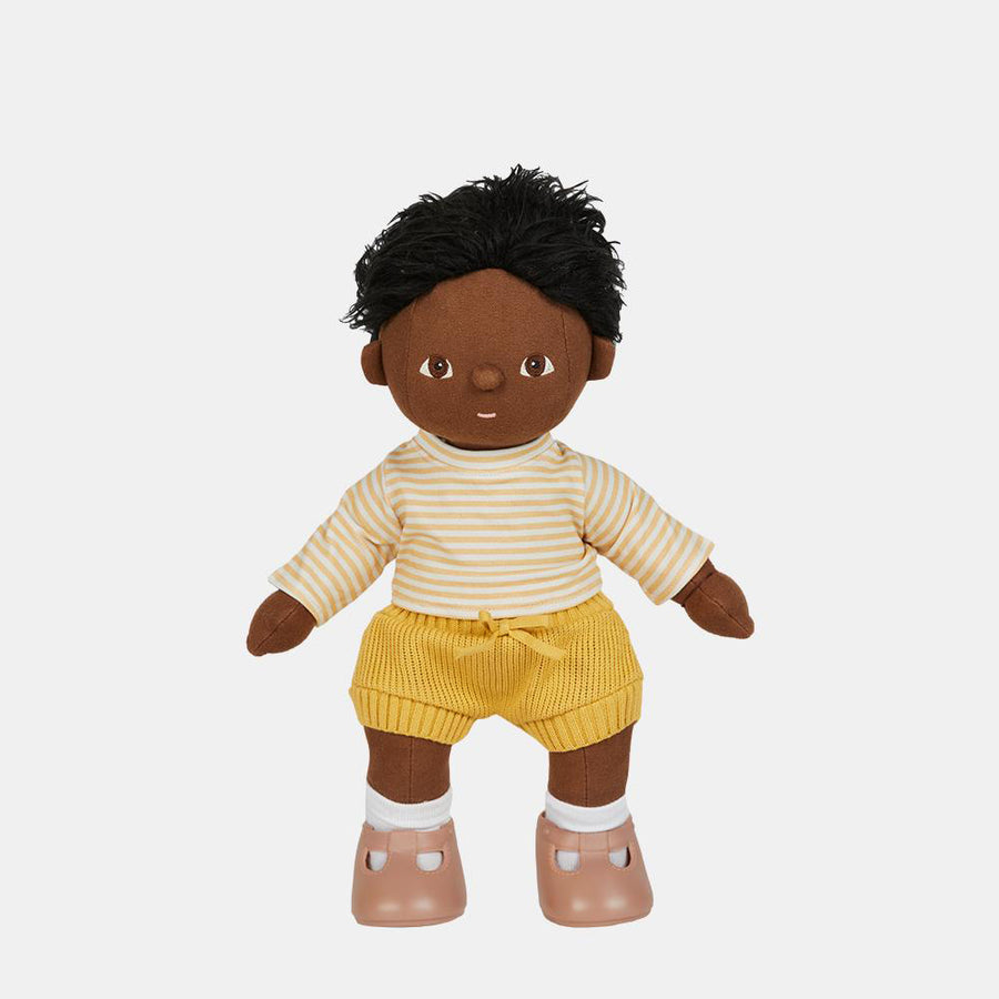 Olli Ella dinkum doll stood on a grey background wearing the honey stripe outfit