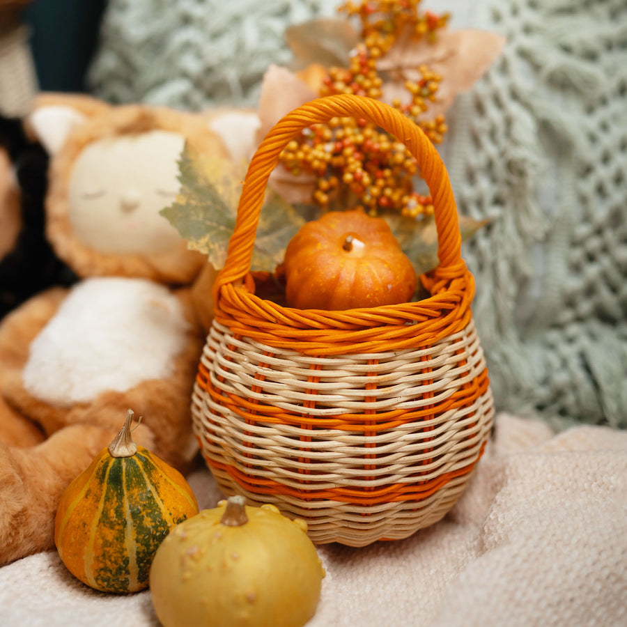 child holding basket placing a sweet inside