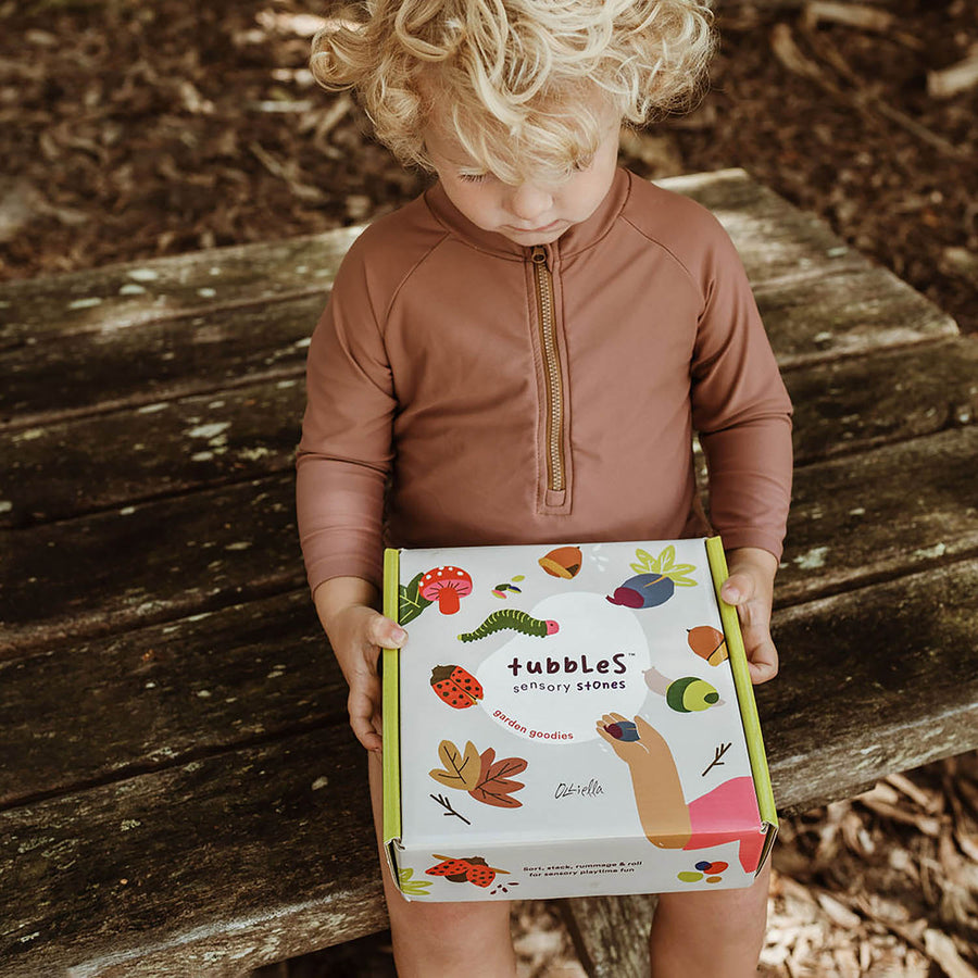 Child holding the Garden Goodies Tubbles Stone box in their hands to show the size of the box