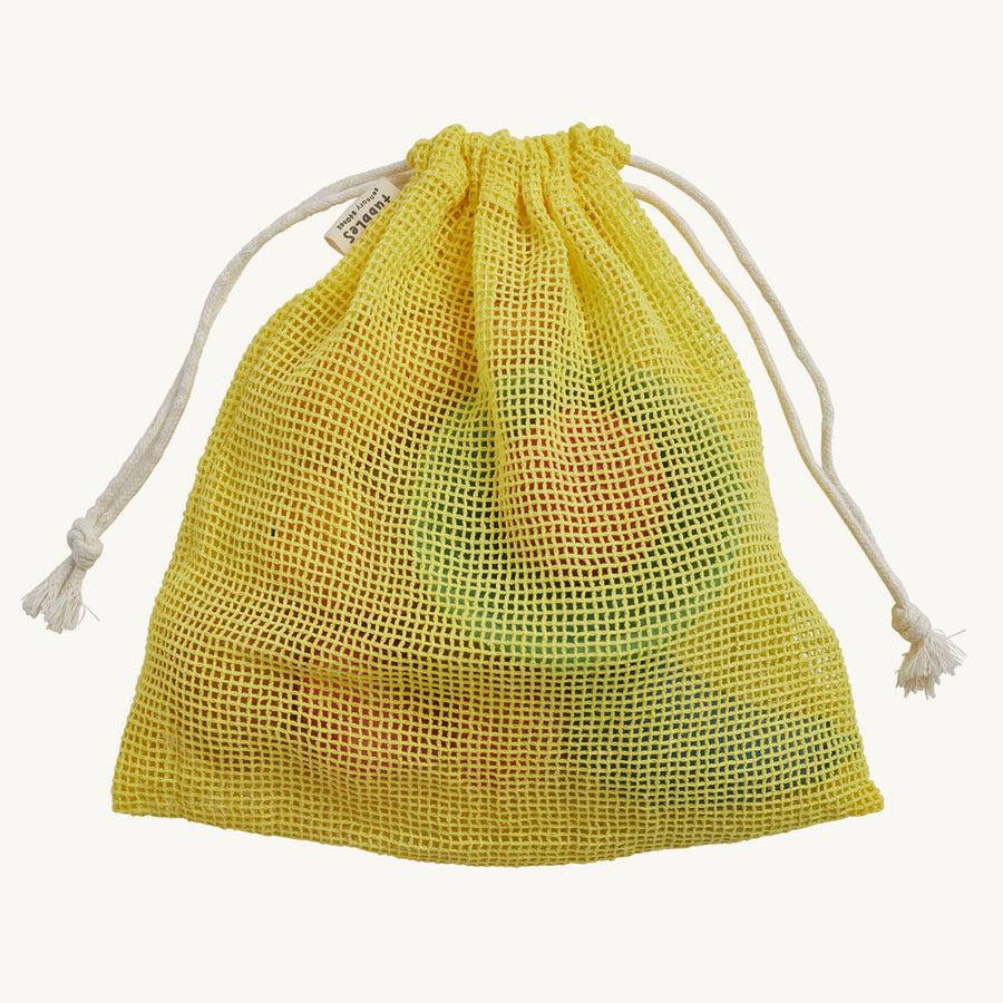 showing the vegetables and a yellow draw string bag