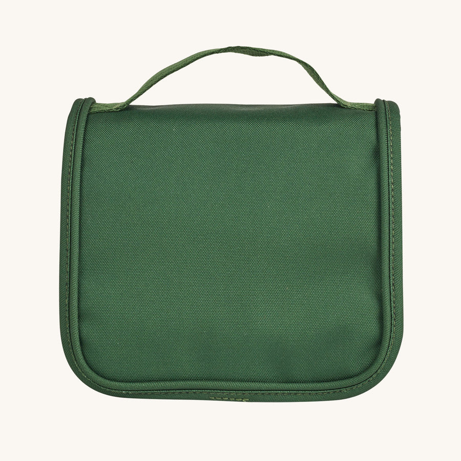 Olli Ella See-Ya Wash Bag in Forest Green in front of the Olli Ella Travel Case in Forest Green