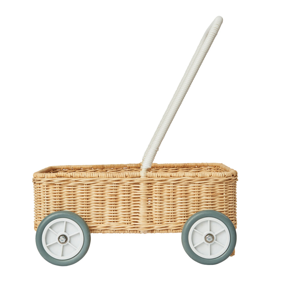 Side of the Olli Ella handmade rattan baby Wamble Walker basket on a white background