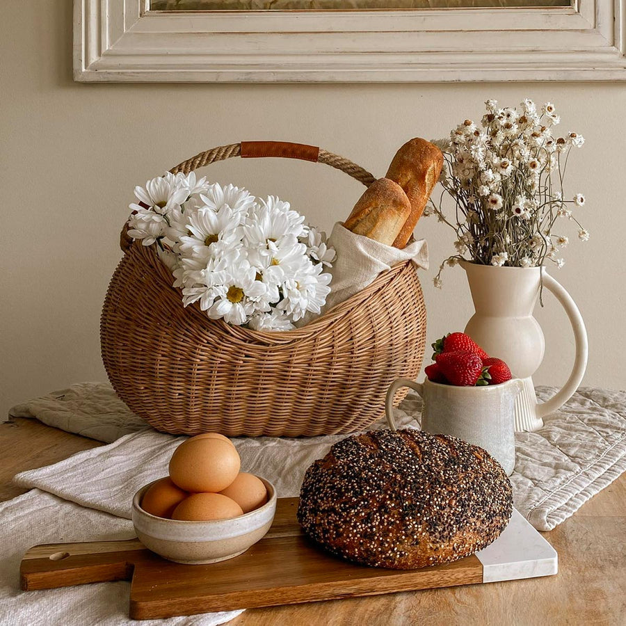 Close up of the Olli Ella half moon rattan handled basket