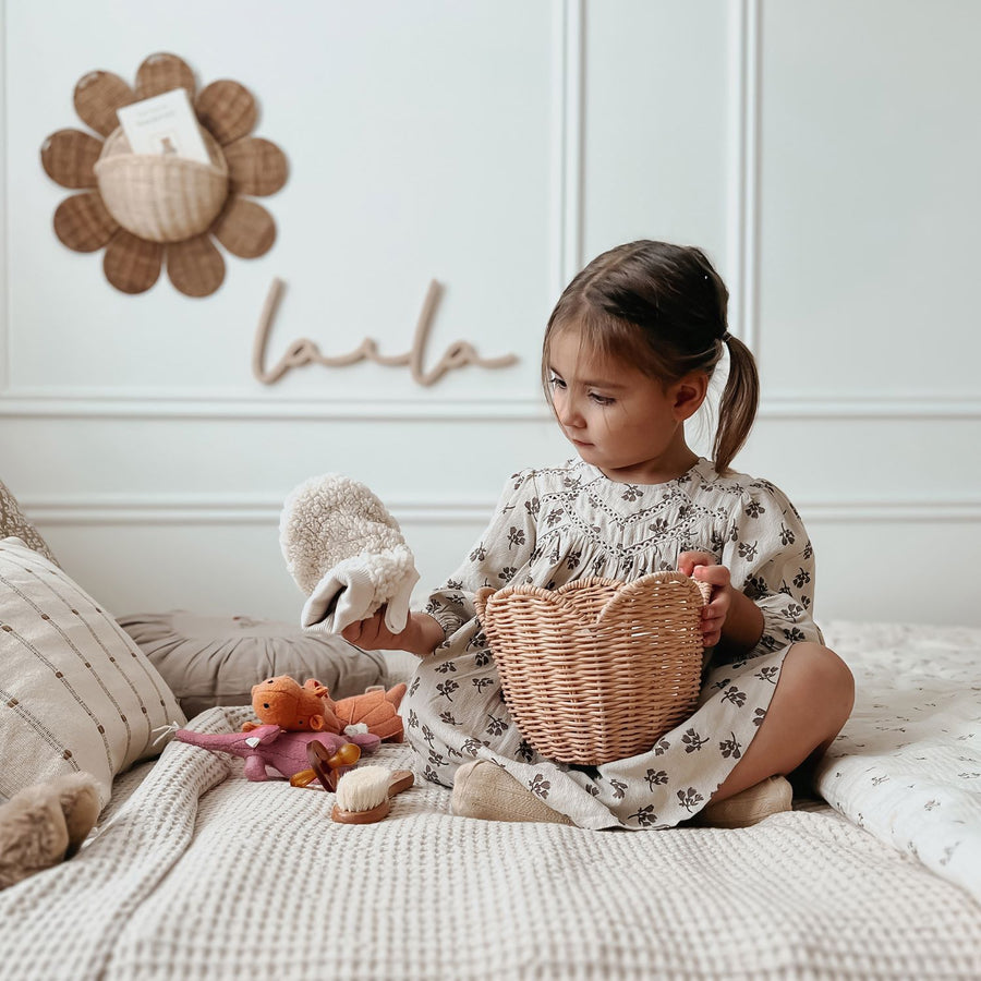 and the smaller basket is holding brushes on the lower shelf.