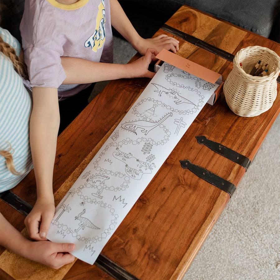 Two children roll out the colouring sheet from the Olli Ella Playpa Mini Pack Dino.