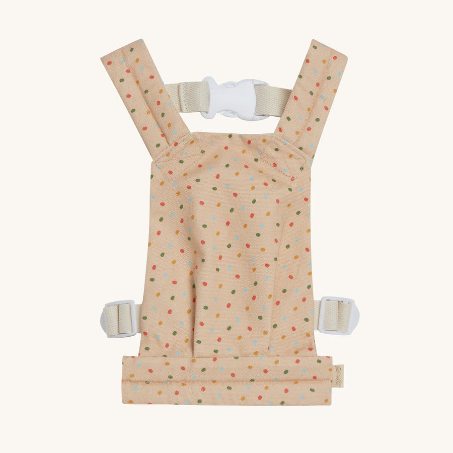 The Dinkum Doll Gumdrop Carrier is peach cream with an all-over multicolour jellybean pattern