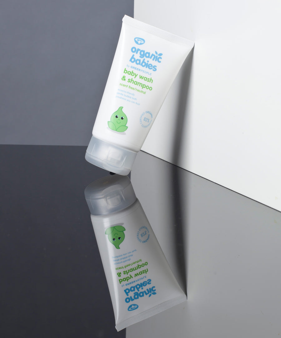 Organic Babies Baby Wash & Shampoo Scent Free placed on a mirrored surface. 