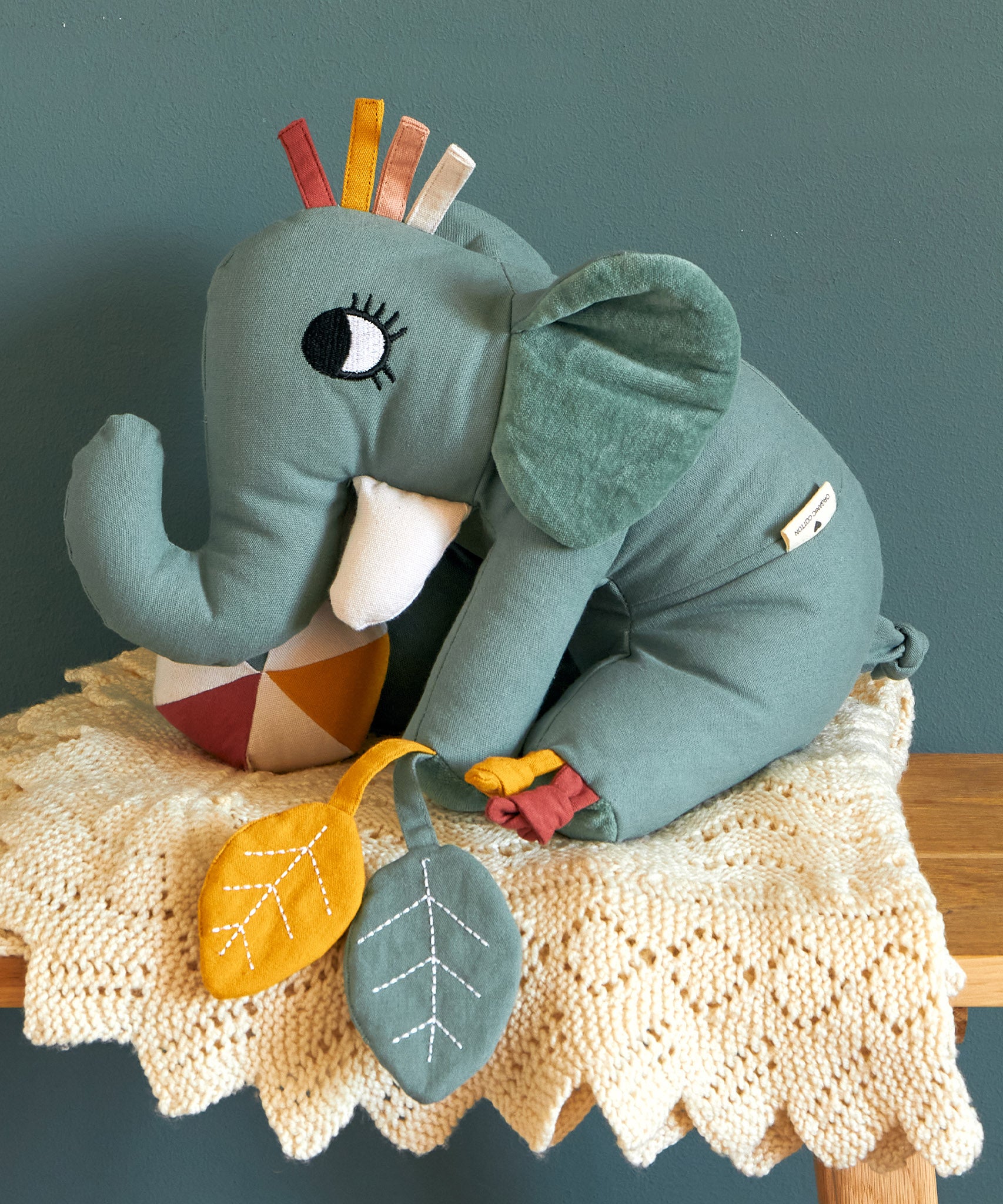 The Roommate Elephant activity toy with a friendly face embroidery