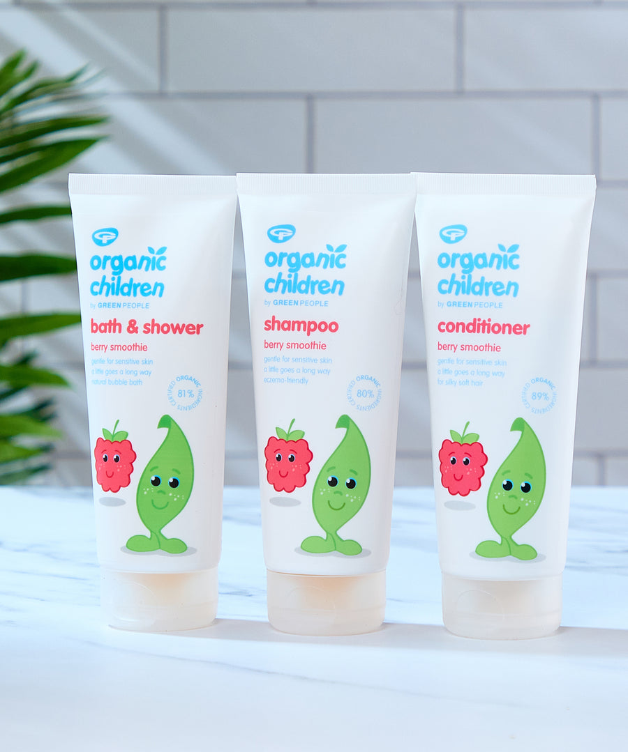 Organic Children Berry Smoothie collection, bath & shower wash, shampoo and conditioner all placed on a marble style surface in a bathroom. 