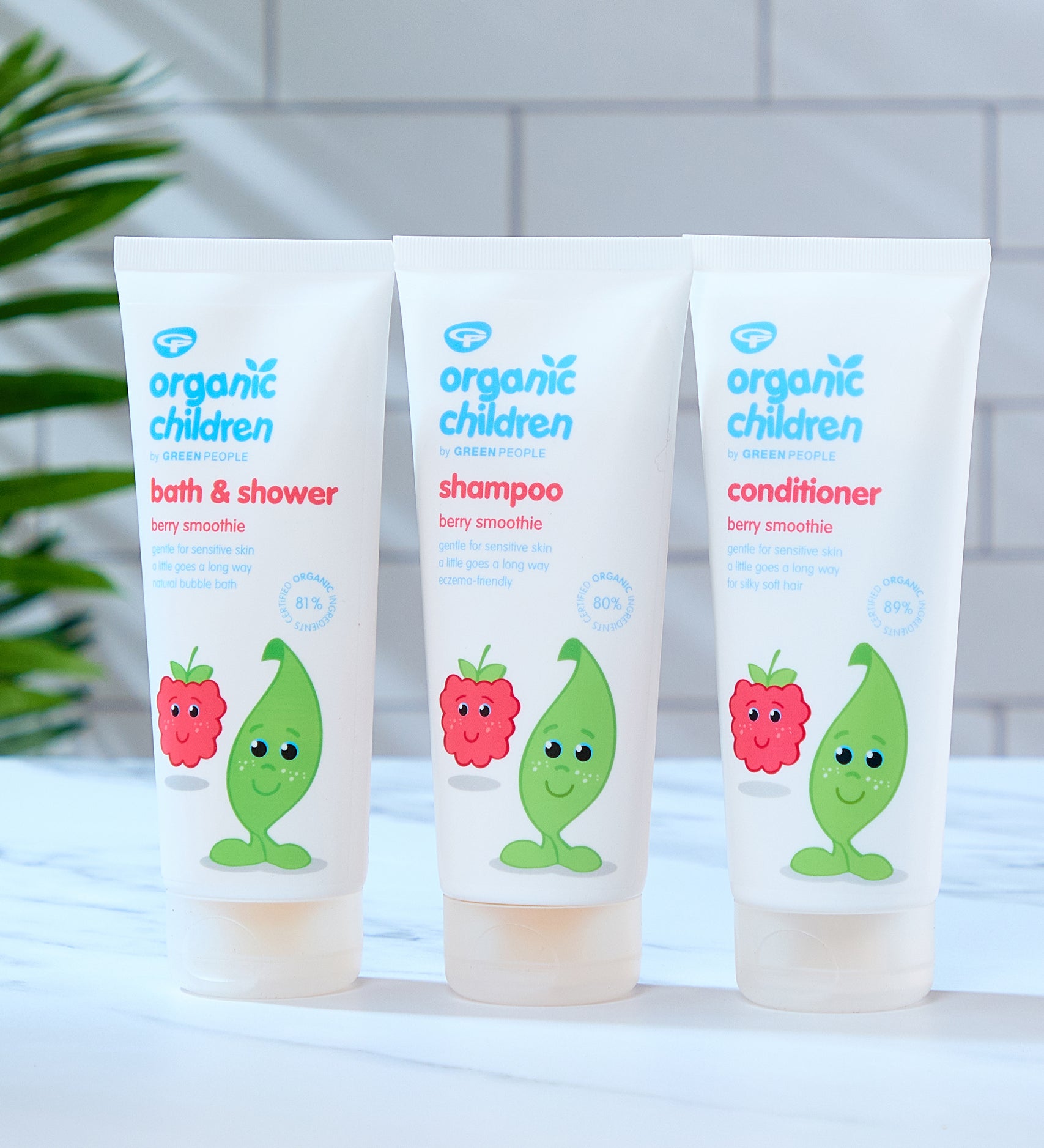 Organic Children Berry Smoothie collection, bath & shower wash, shampoo and conditioner all placed on a marble style surface in a bathroom. 