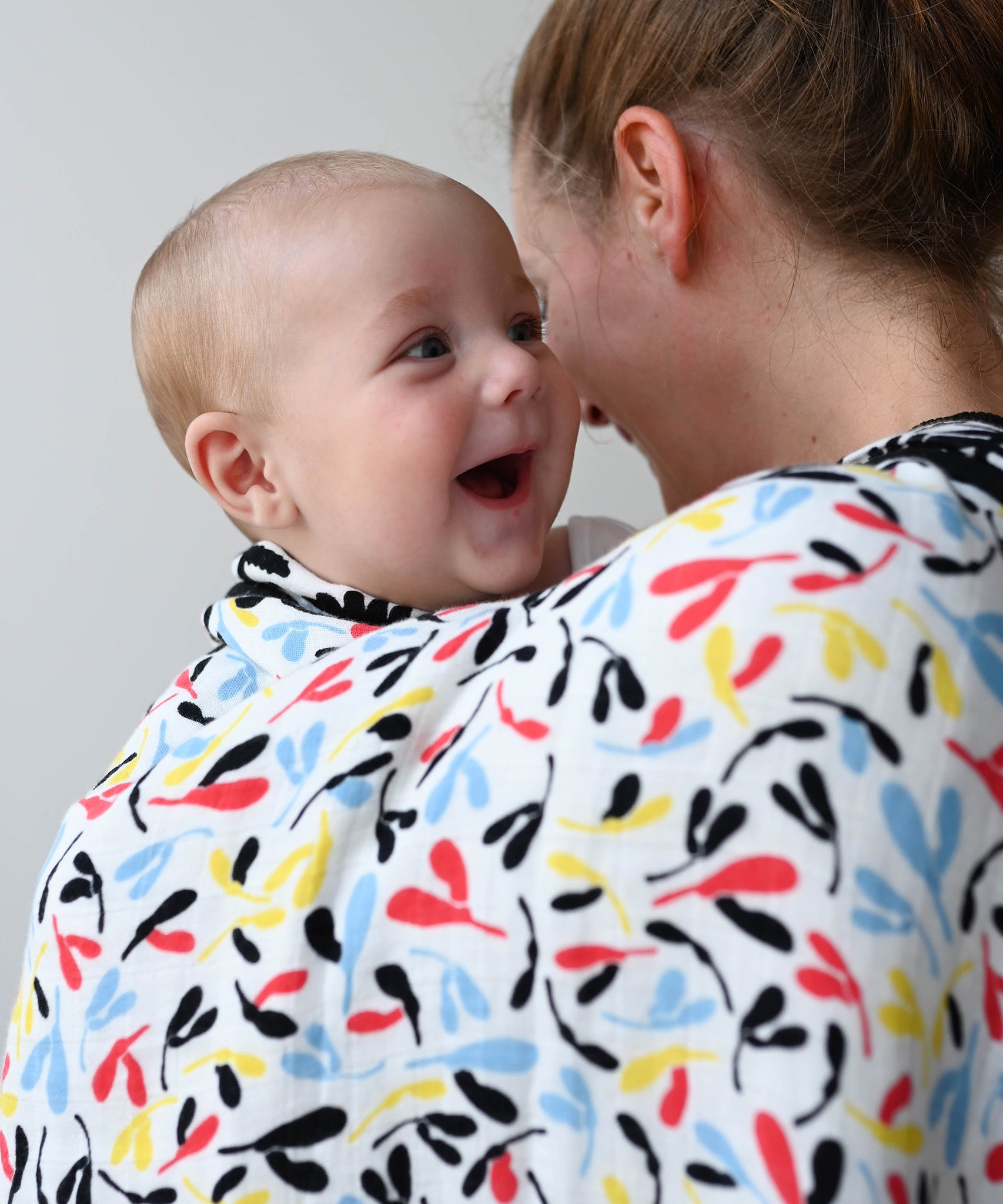 The Etta Loves Reversible Organic Cotton Muslin Blanket - Plant Print with black and white Ferns on one side