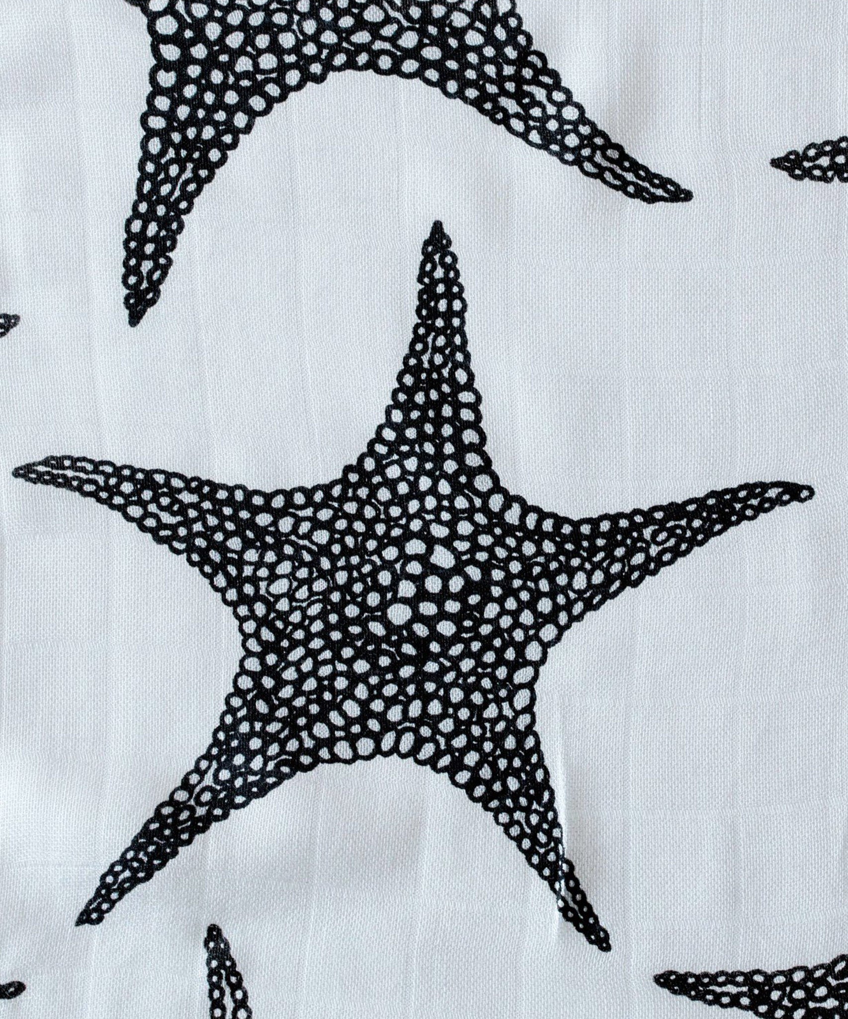 The Etta Loves XL Starfish muslin cloth tucked into a black bag