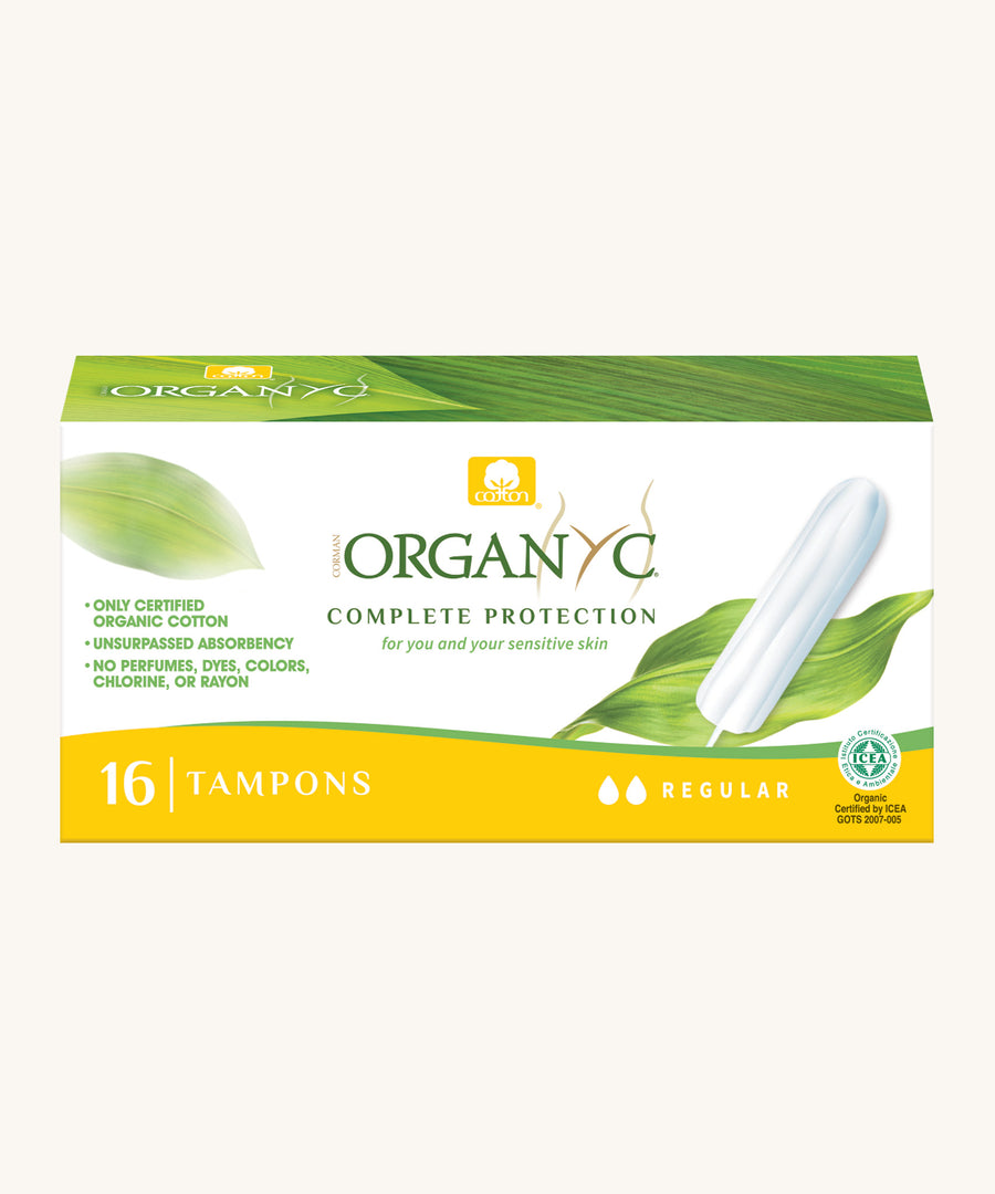 Regular tampons in a box on a cream background.