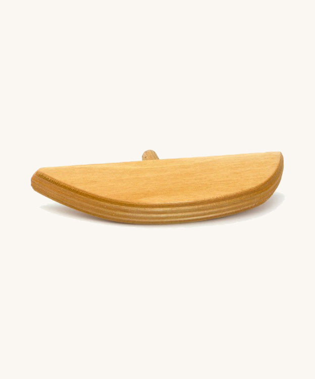 A wooden bird perch on a cream background