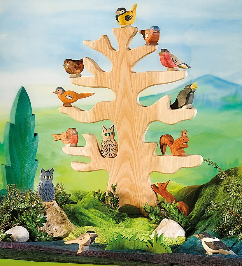 Ostheimer bird tree set up in a play scene with wooden bird figures and animals.