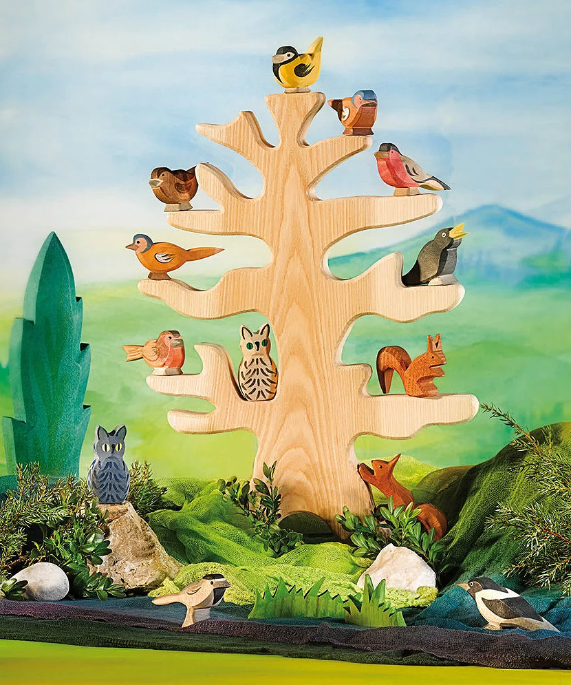 Ostheimer bird tree set up in a play scene with wooden bird figures and animals.