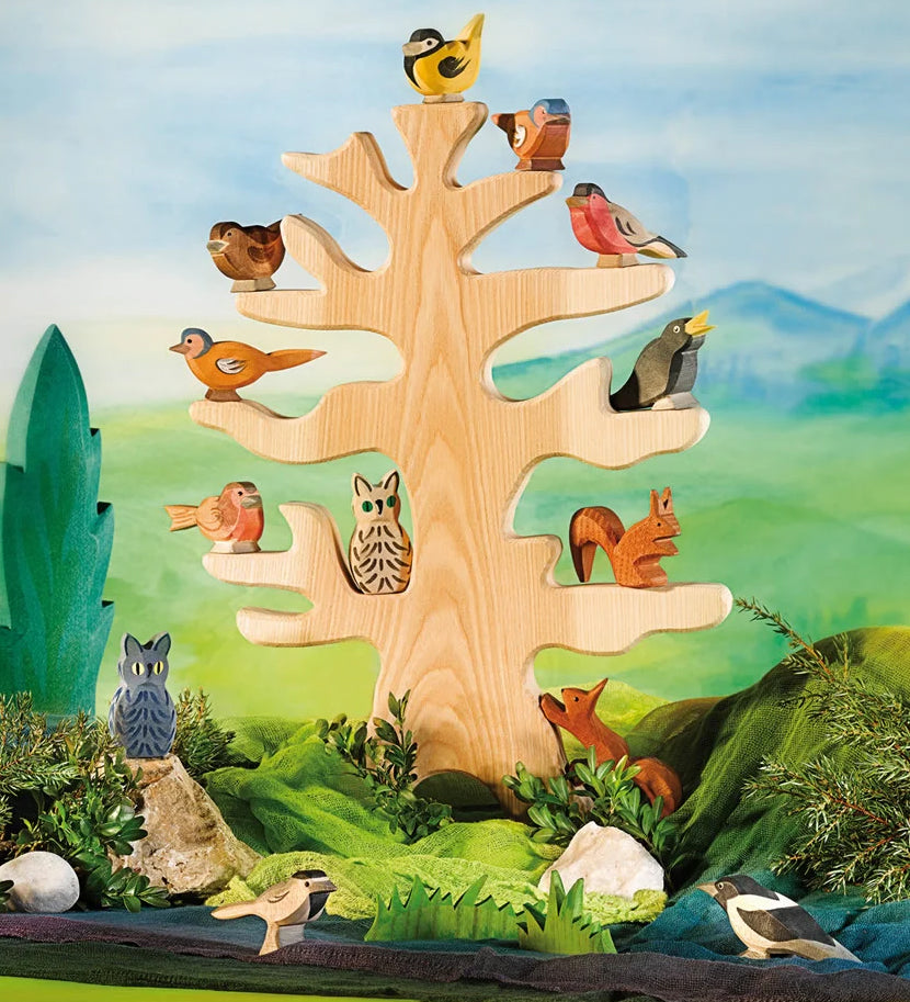 Ostheimer bird tree with wooden bird figures in a small world play scene. 