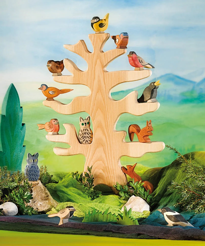 Ostheimer bird tree with wooden bird figures in a small world play scene. 