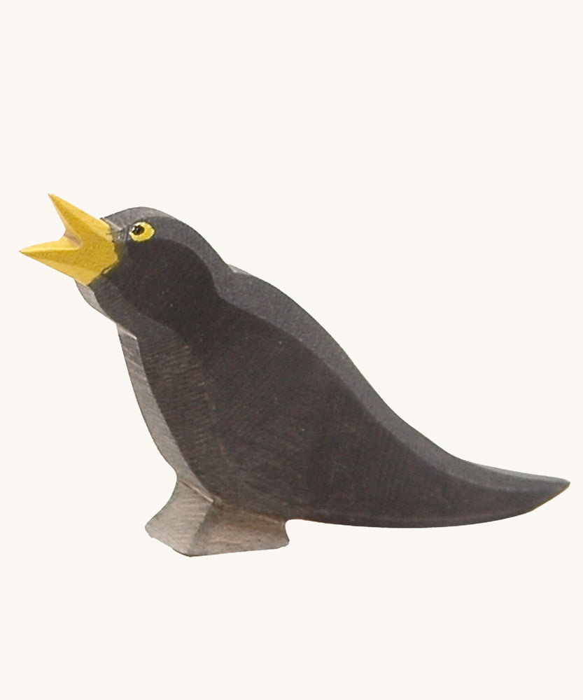 Ostheimer Blackbird wooden figure on a plain background. 