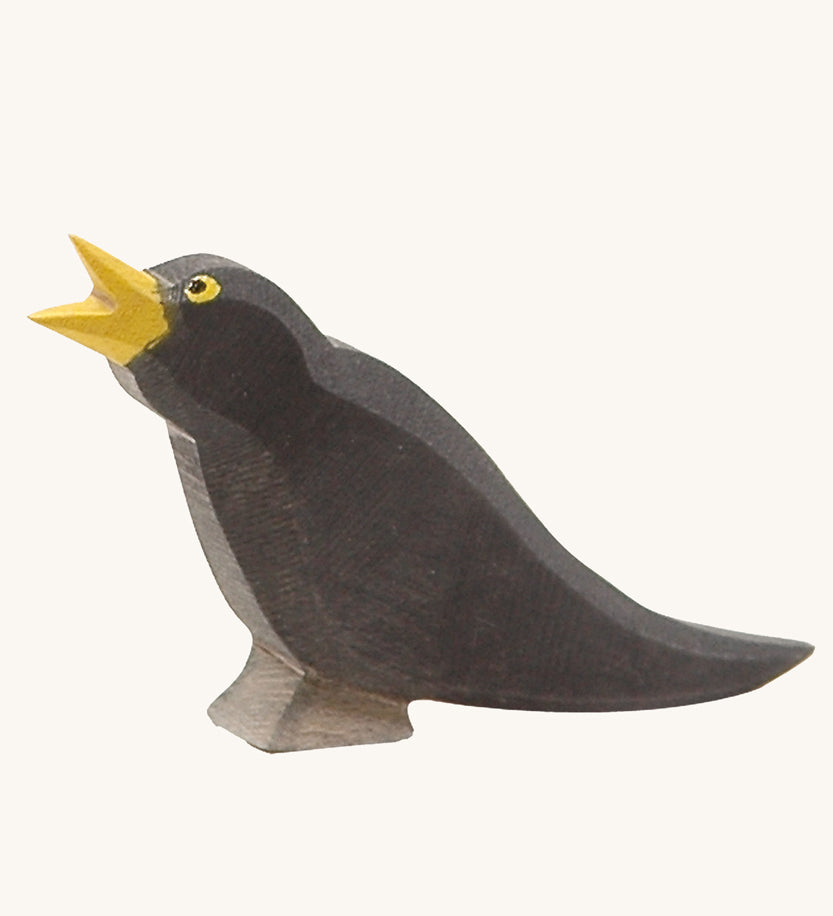 Ostheimer Blackbird wooden figure on a plain background. 