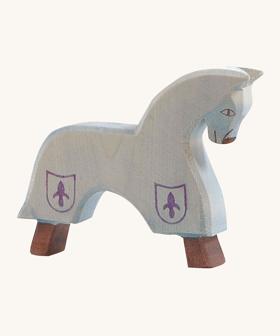 Ostheimer blue wooden horse figure on a cream background