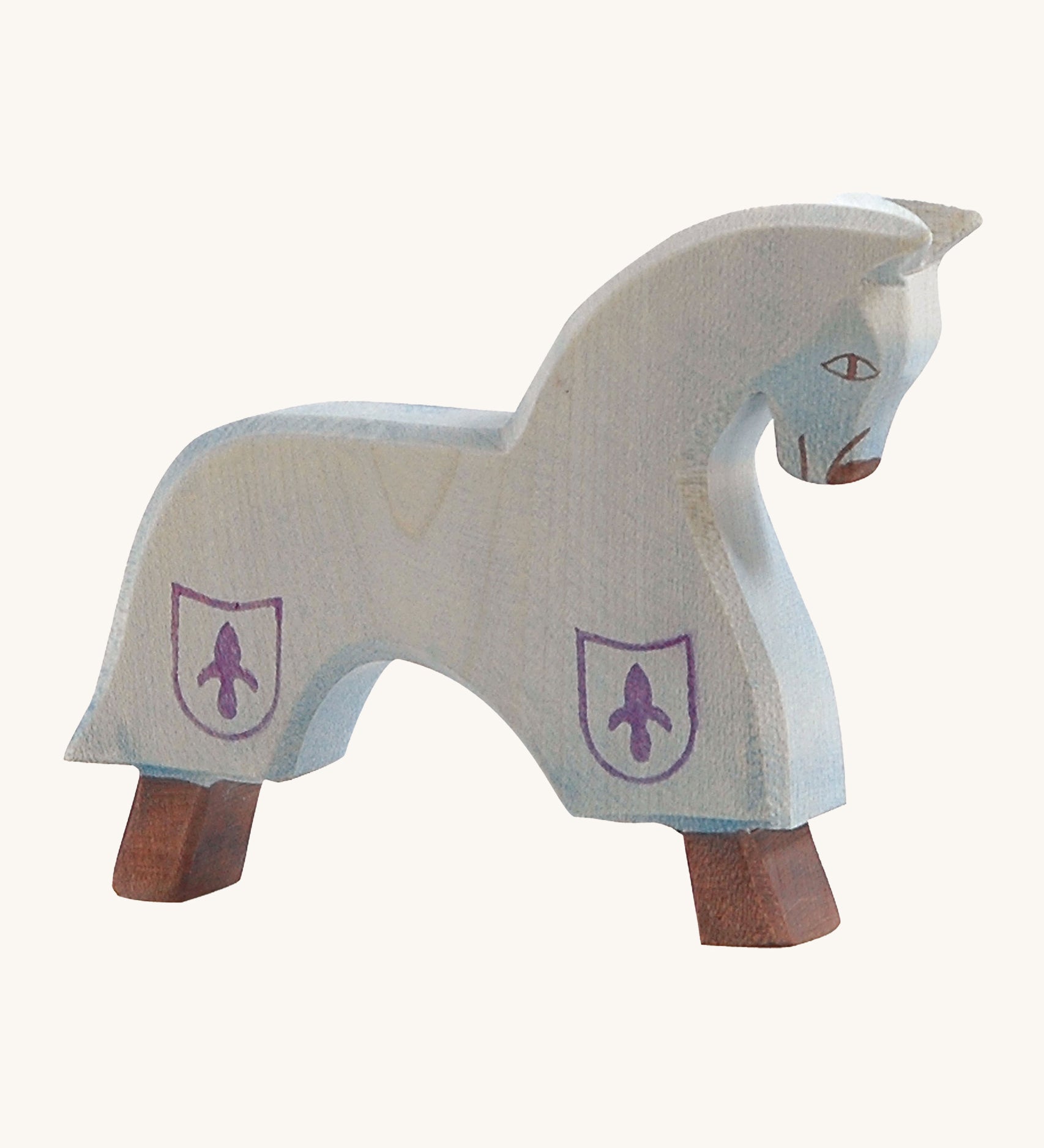 Ostheimer blue wooden horse figure on a cream background