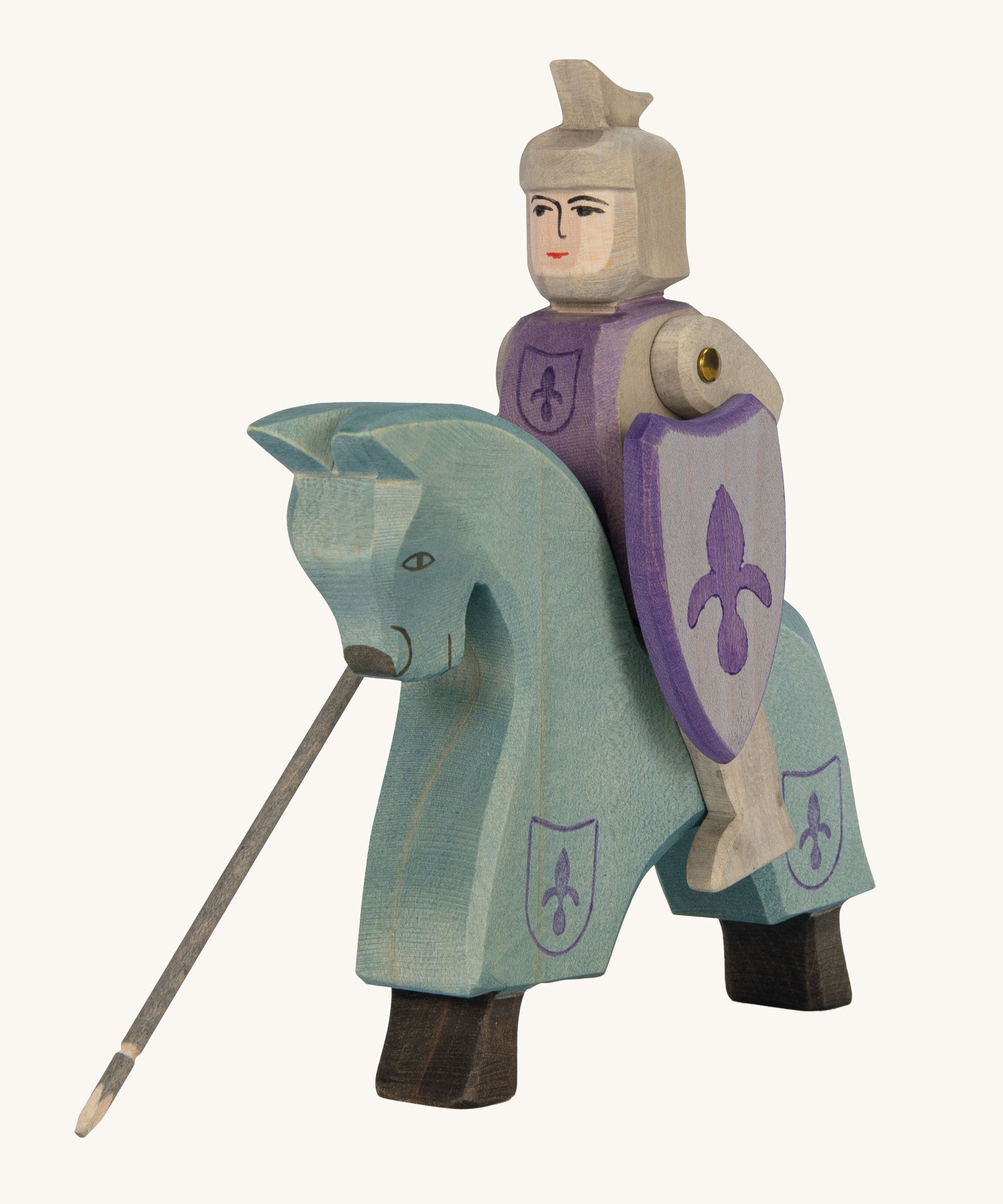 Ostheimer blue wooden horse figure with a wooden Ostheimer blue knight sitting on the horse on a cream background