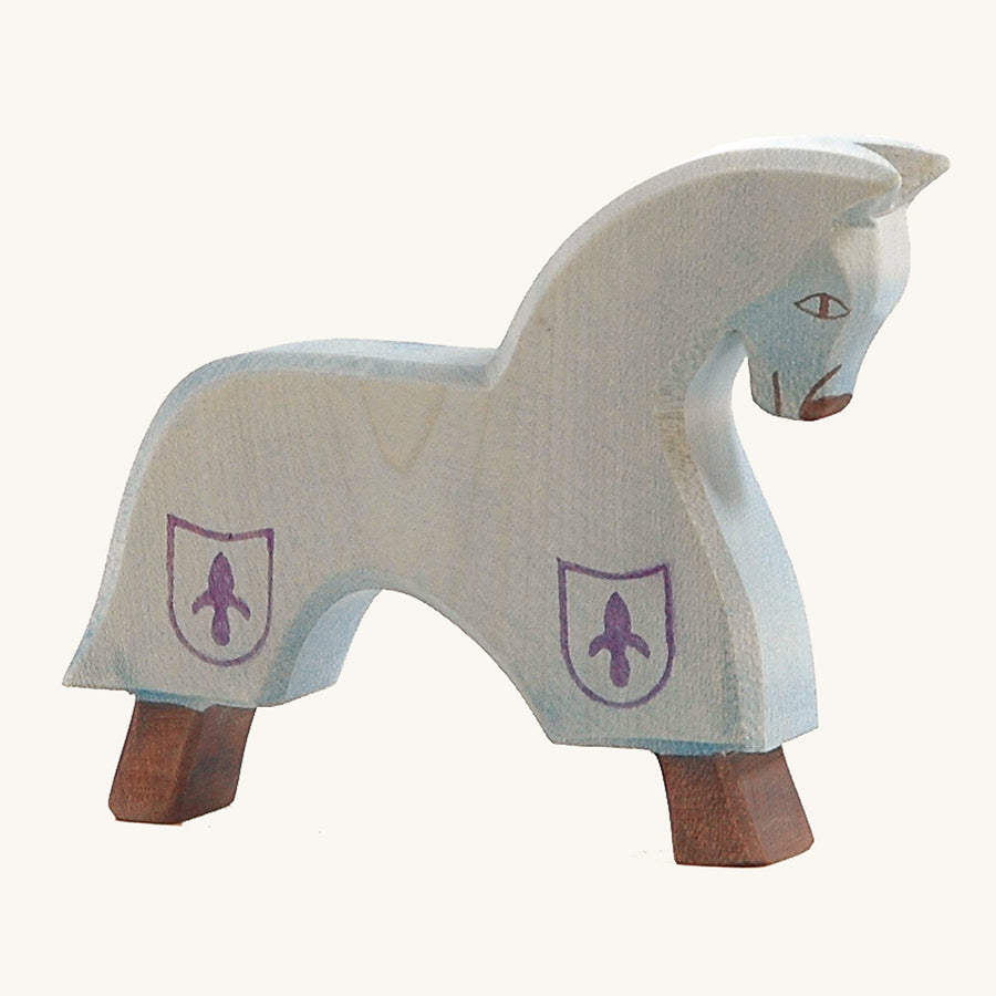 Ostheimer blue wooden horse figure on a beige background