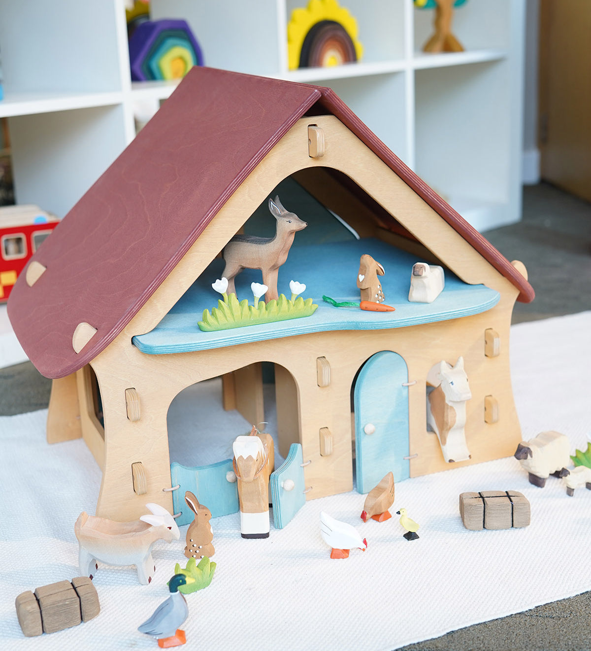 Ostheimer wooden farm house with light red roof and light blue doors