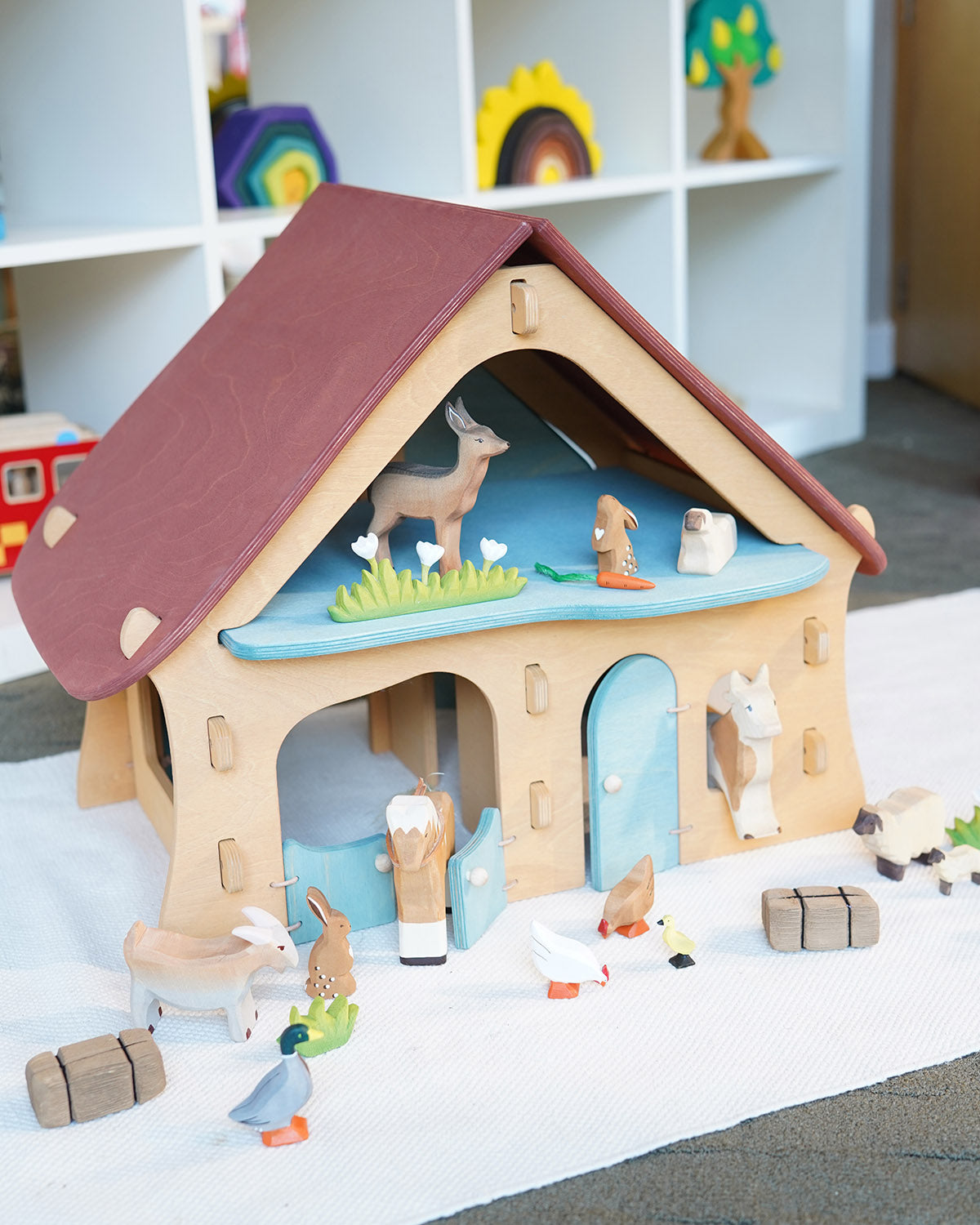 Ostheimer wooden farm house with light red roof and light blue doors