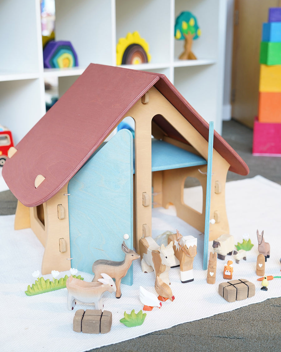 Ostheimer wooden farm house with light red roof and light blue doors