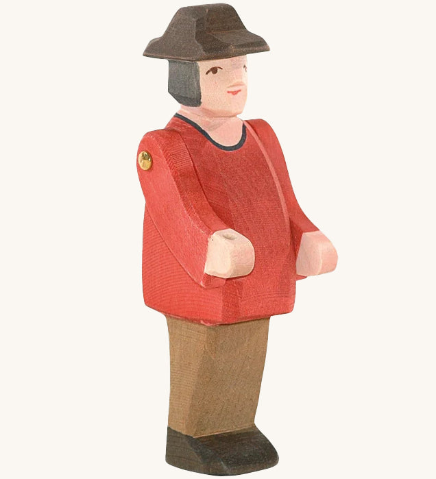 Ostheimer Farmer Man on a plain background. The wooden toy figure has movable arms and has a painted red top. 