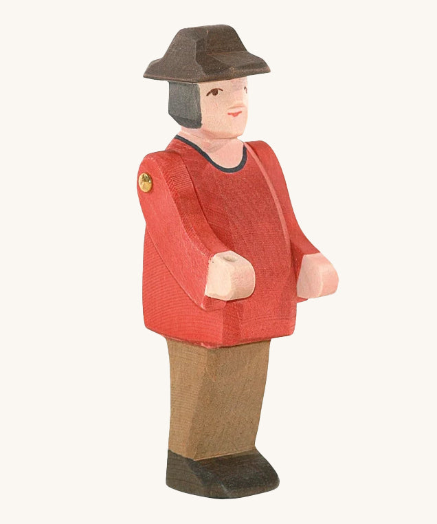 Ostheimer Farmer Man on a plain background. The wooden toy figure has movable arms and has a painted red top. 