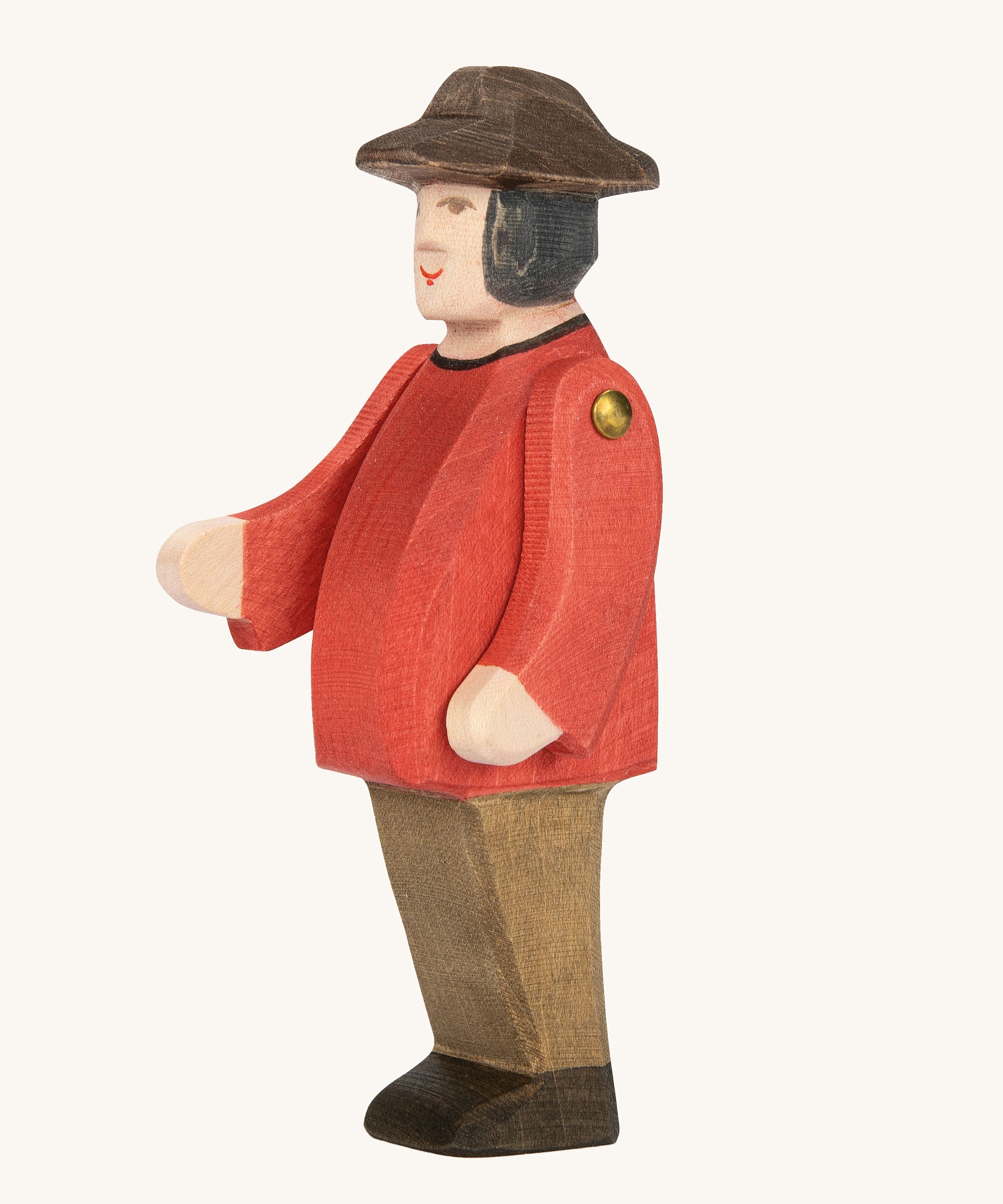 Ostheimer Farmer Man on a plain background. The wooden toy figure has movable arms and has a painted red top. 