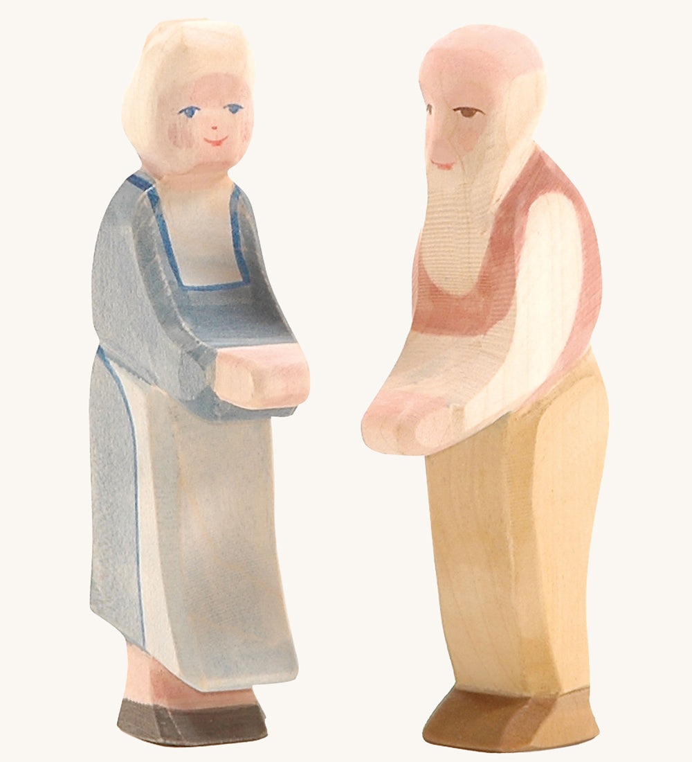 Ostheimer grandmother and grandfather wooden toy figures on a plain background. 