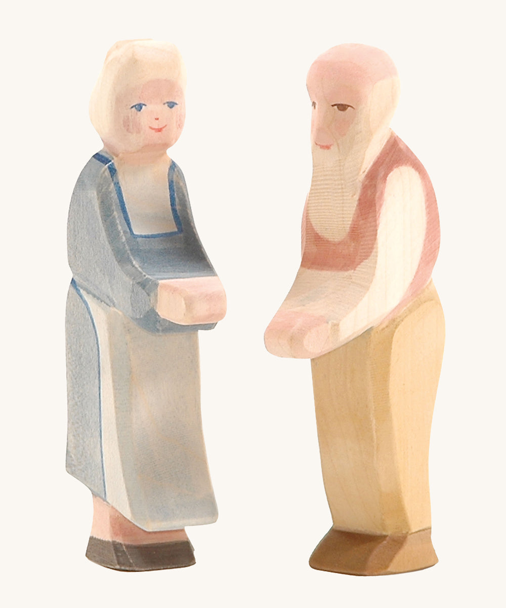 Ostheimer grandmother and grandfather wooden toy figures on a plain background. 