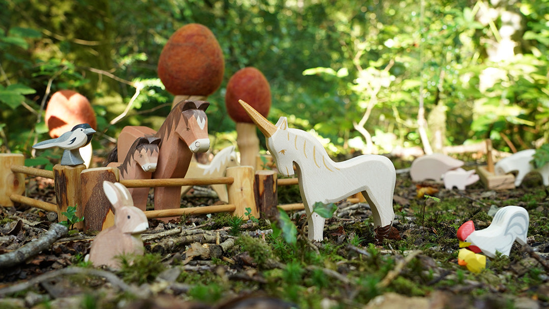 A playscene in the forest featuring Ostheimer handmade wooden horses and other animals