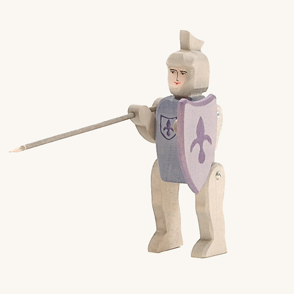 Ostheimer kids handmade wooden blue riding knight figure stood on a beige background