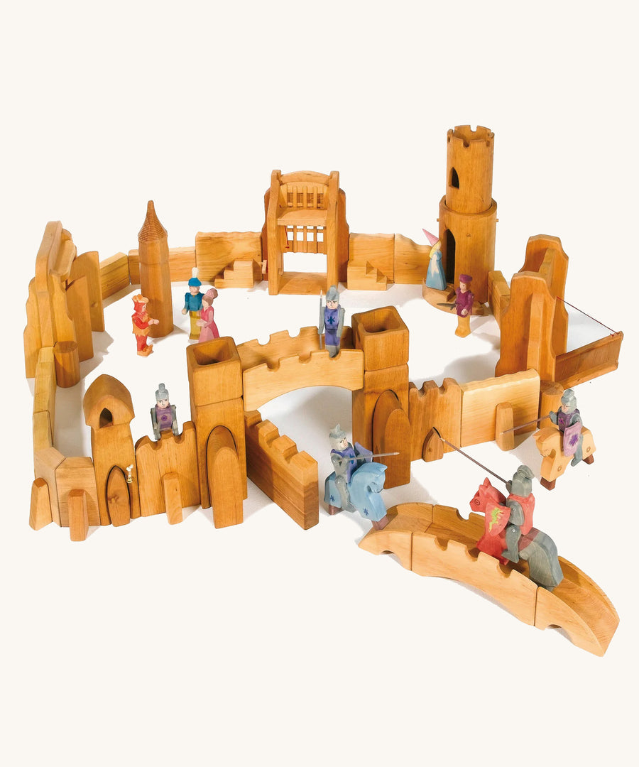 Ostheimer kids wooden castle toy set laid out on a cream background