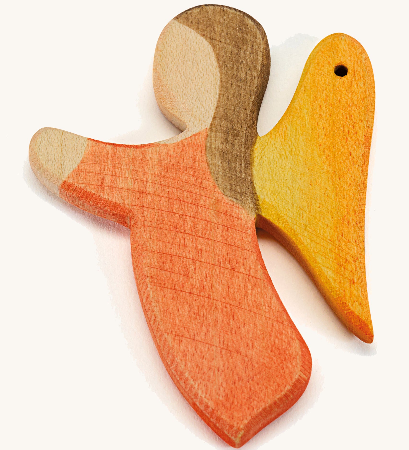 a orange wooden angel figure on a cream background