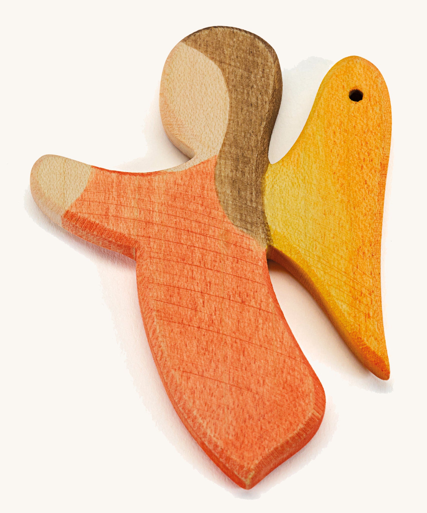 a orange wooden angel figure on a cream background